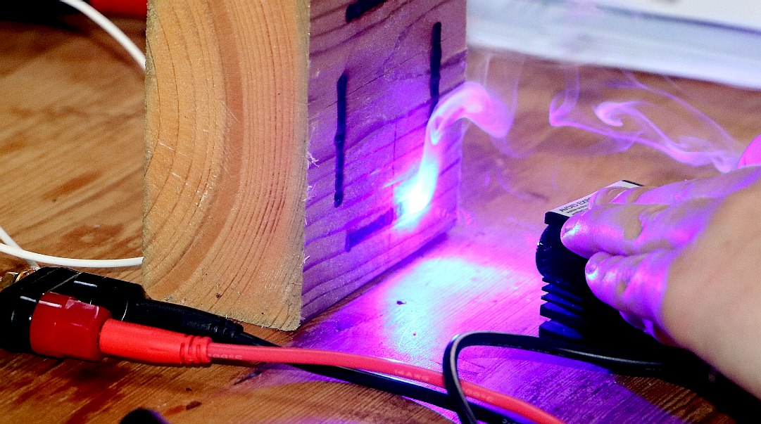 Using a laser to burn through cardboard and cut wood
